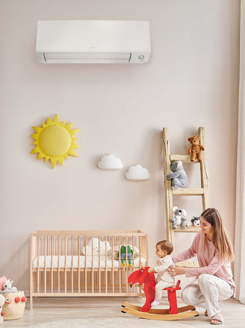 mother and baby in room with Perfera air conditioner